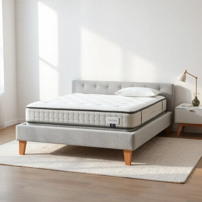 A premium mattress on a modern bed with neutral bedding and soft natural light