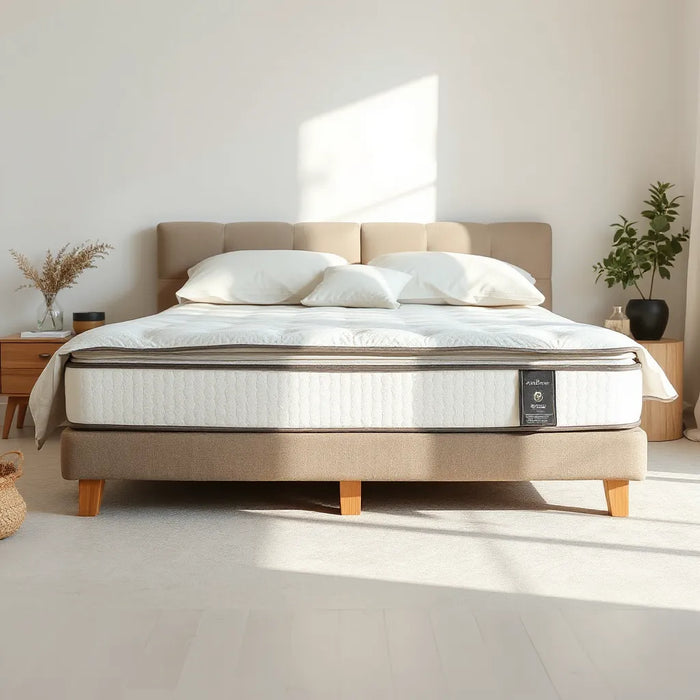 Neatly made bed with a premium-looking mattress in a bright, minimalist bedroom