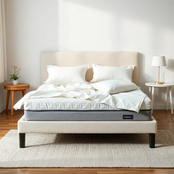 Neatly made bed in a modern bedroom with a premium hybrid-style mattress under soft daylight
