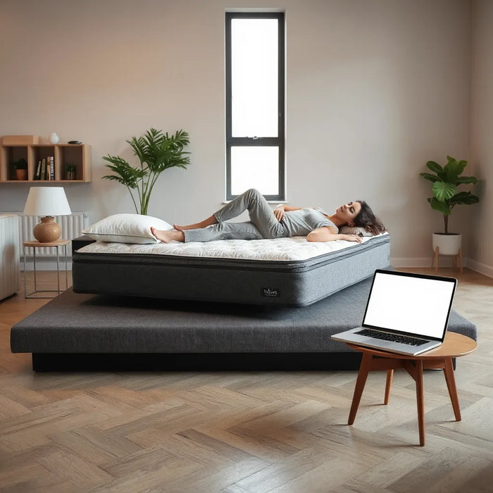 Person testing a modern mattress while browsing options on a tablet in a clean showroom setting