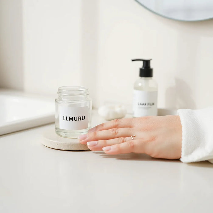 Minimal skincare setup with a fragrance-free moisturizer jar and pump bottle on a bright neutral vanity
