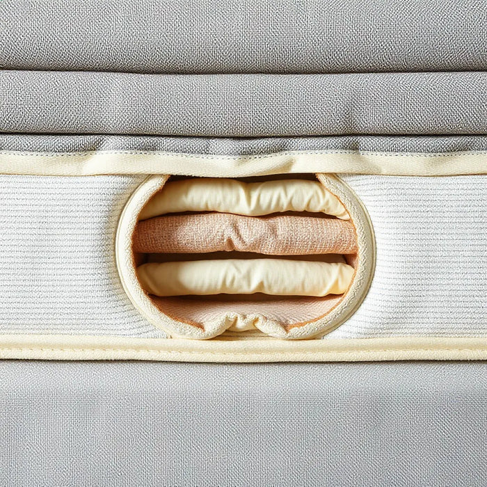 Mattress interior showing dual coil layers with supportive springs under a neutral fabric top