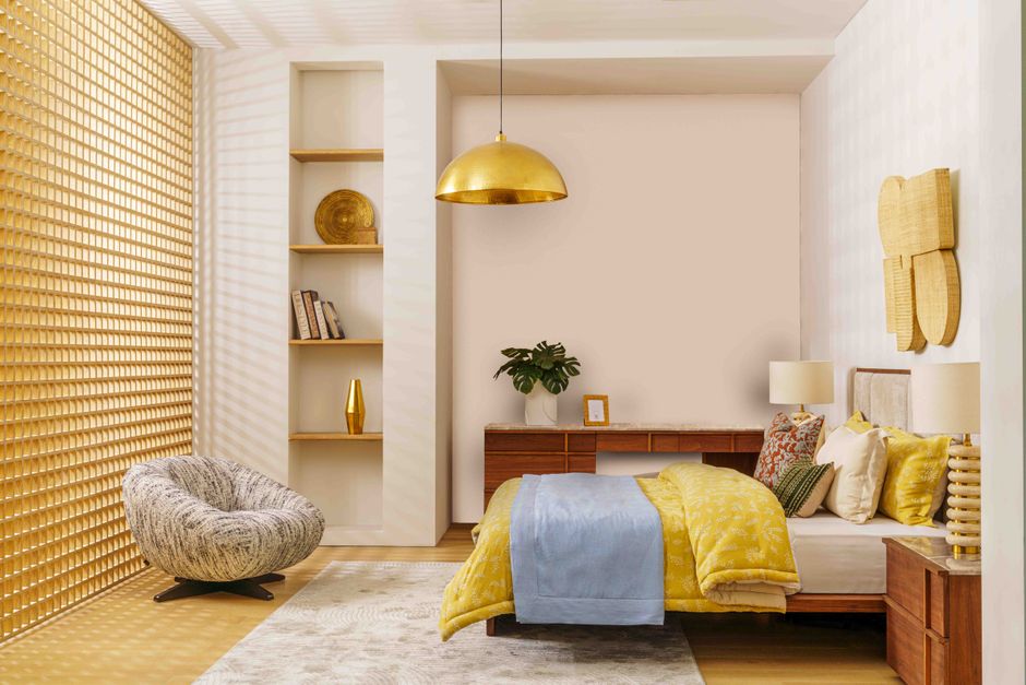 Elegant bedroom design featuring gold, yellow, and blue decor in the UAE.
