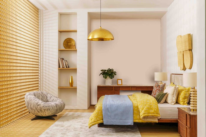 Elegant bedroom design featuring gold, yellow, and blue decor in the UAE.