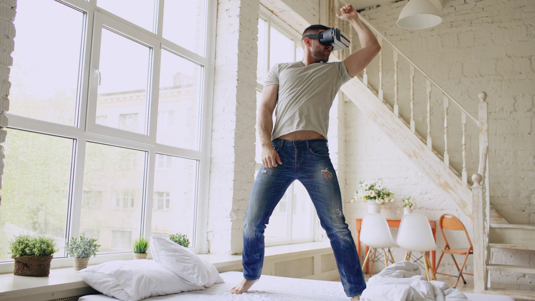Man enjoying virtual reality at home, showing excitement and immersion.