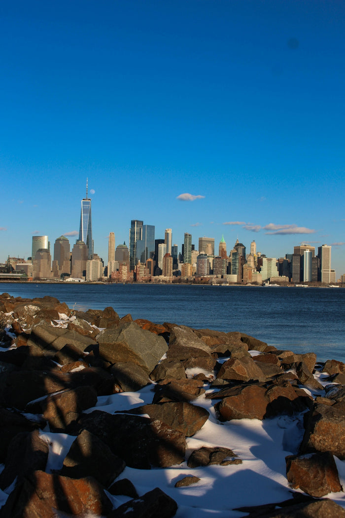 a large body of water with a city in the background
