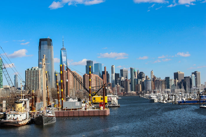 a harbor filled with lots of boats next to tall buildings