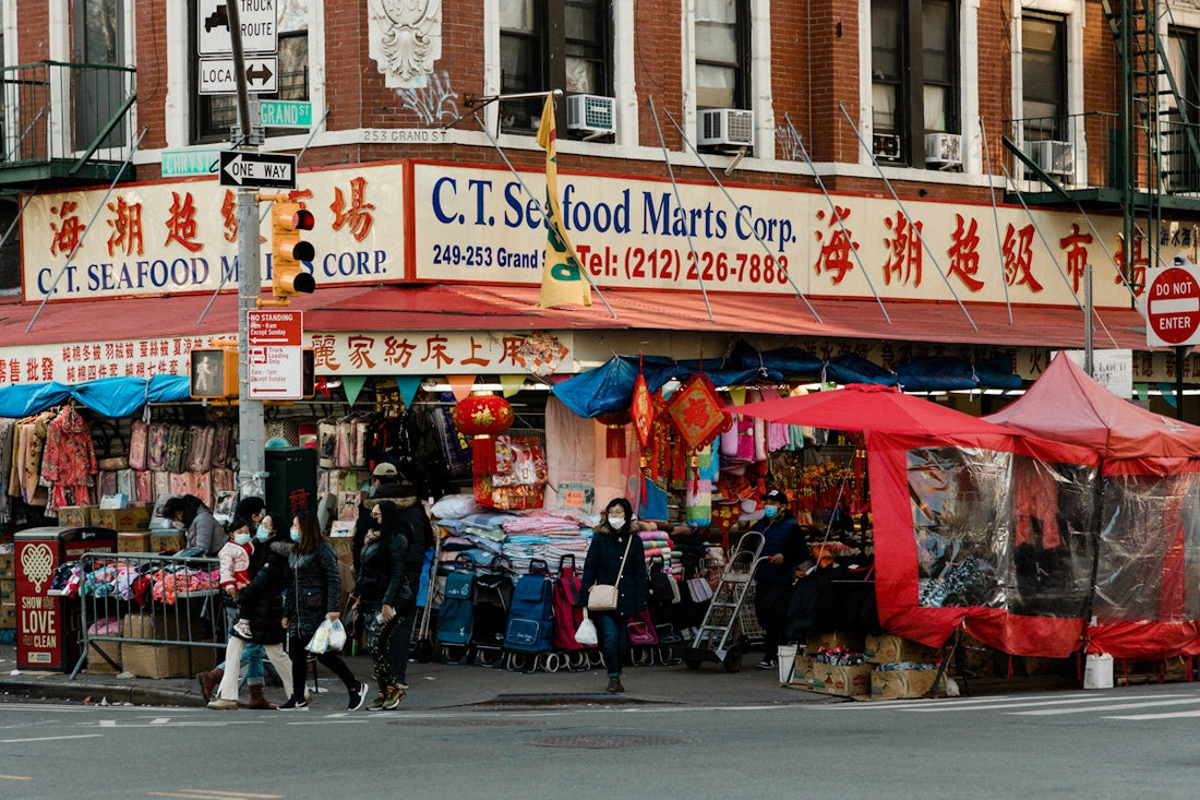 a group of people standing outside of a store