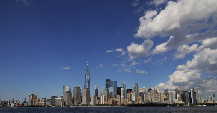 a city skyline with blue sky and clouds