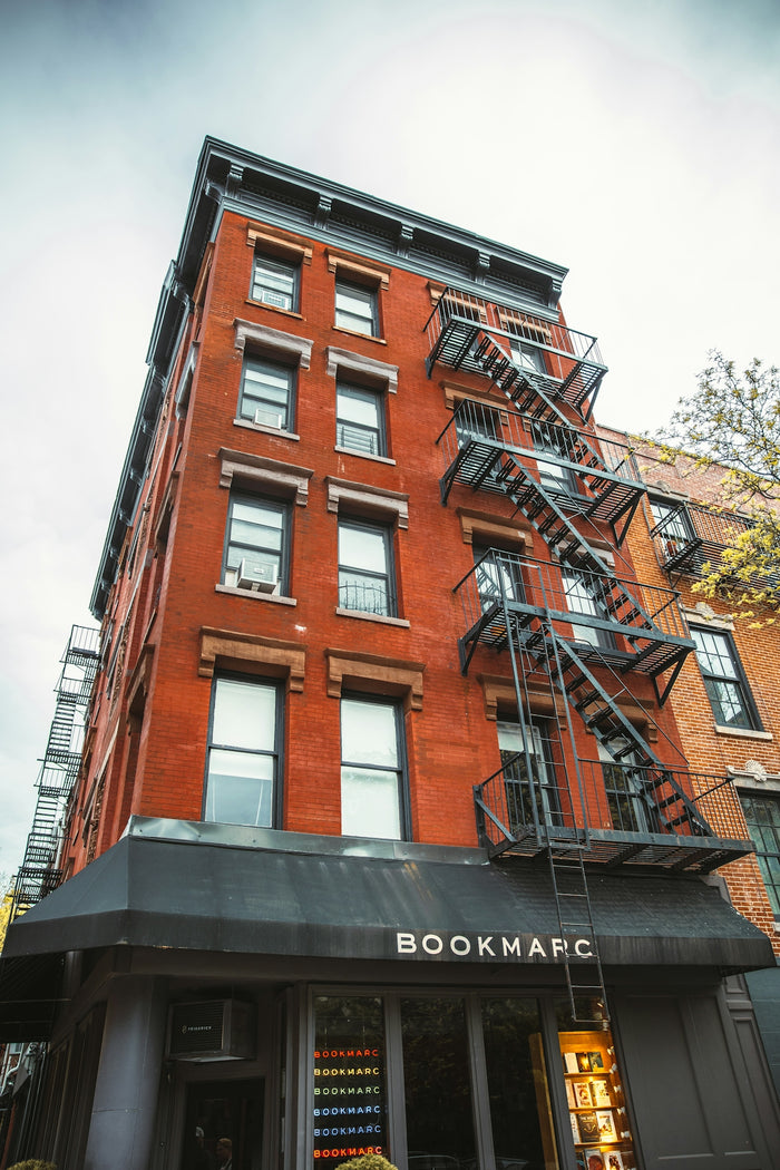 a building with a few balconies and a tree in the background