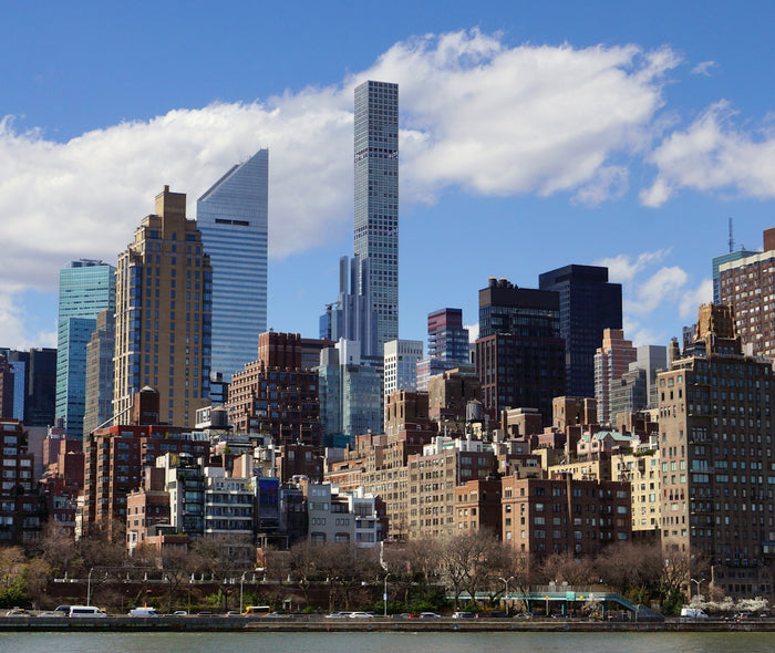 a view of a city with tall buildings and a body of water