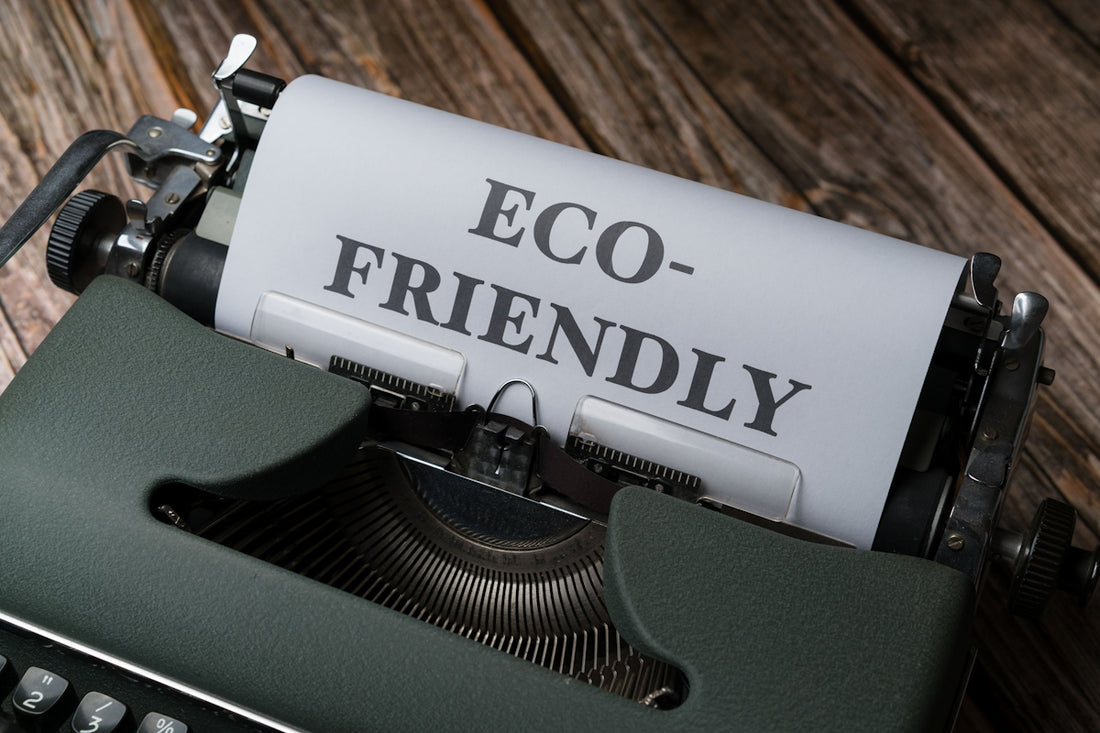 a close up of a typewriter with a paper that reads eco - friendly