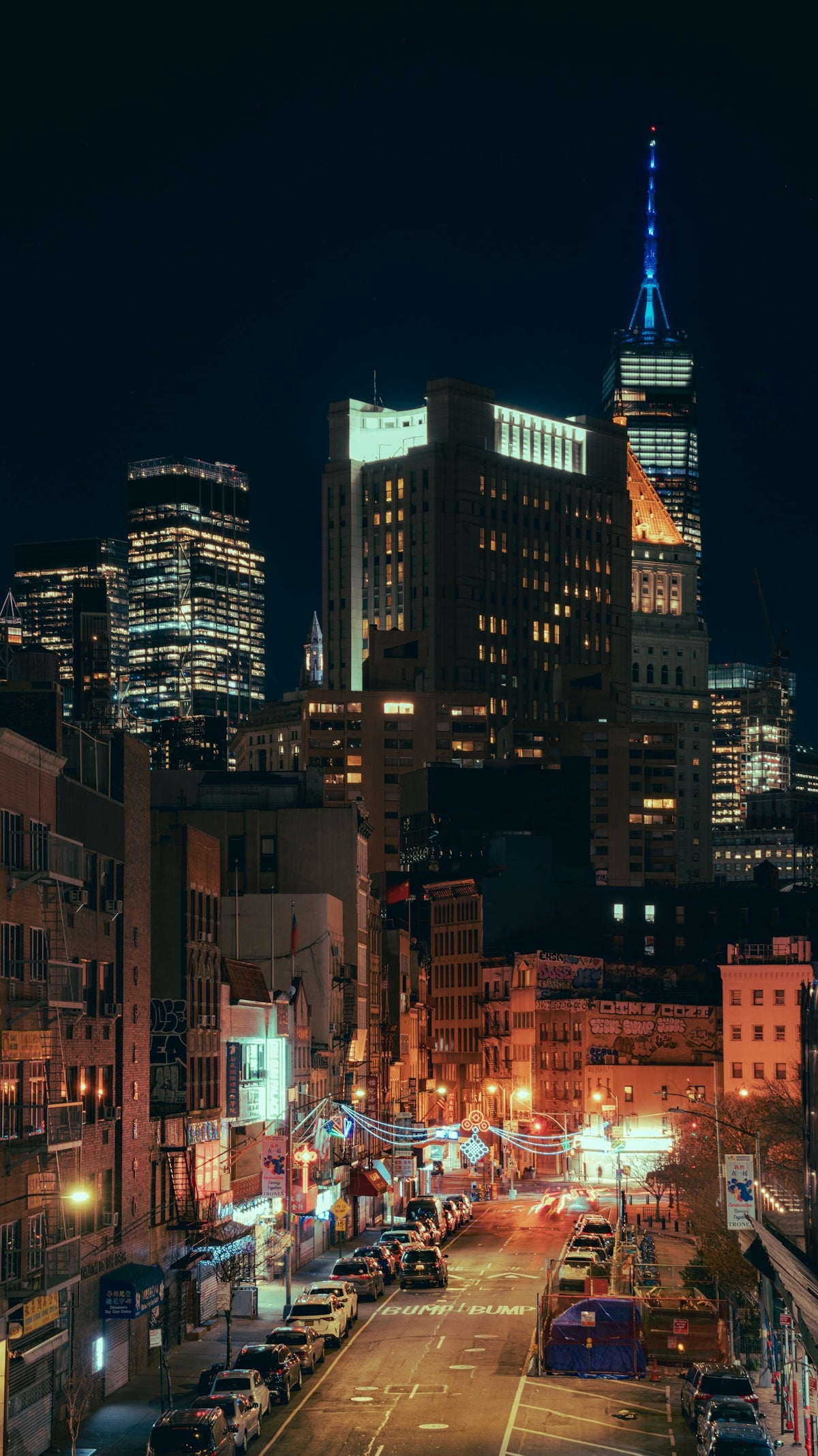 a city at night with a lot of cars parked on the street