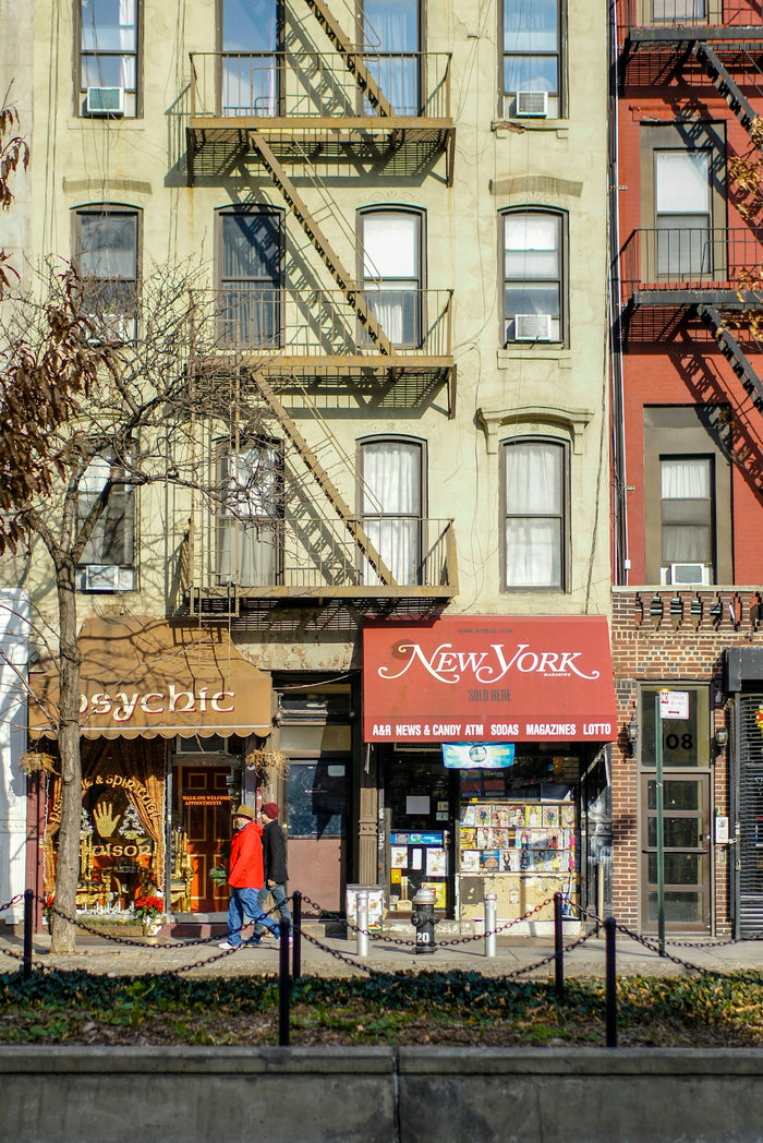 Shops are under buildings with fire escapes.