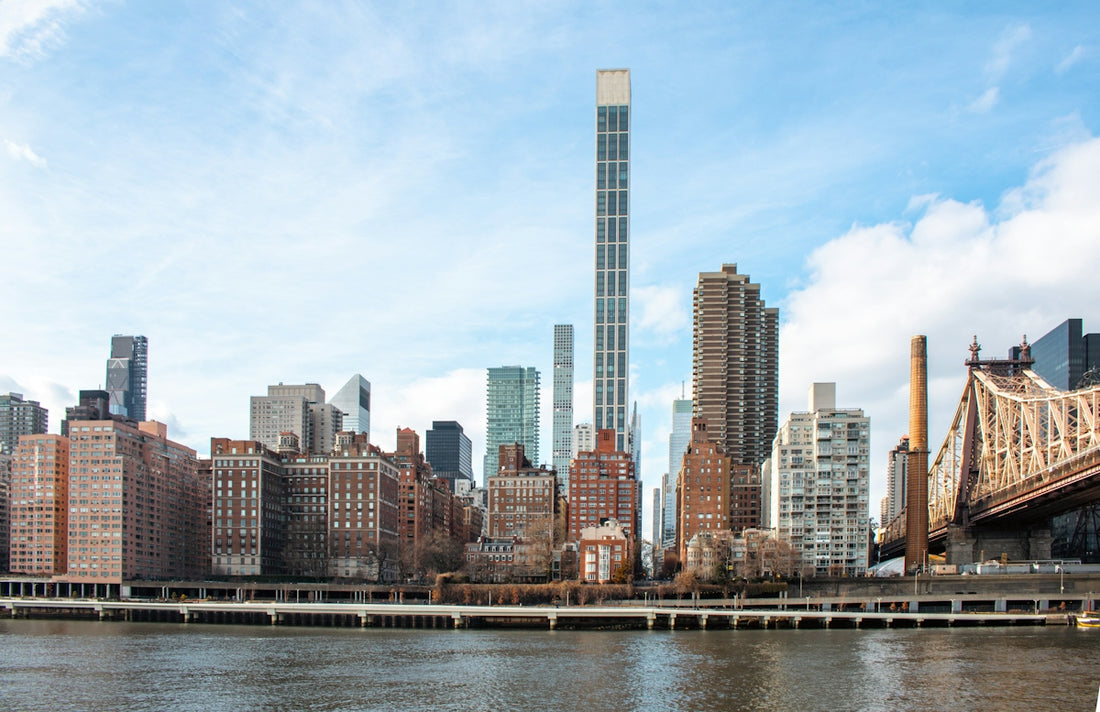Skyscrapers dominate the cityscape against a cloudy sky
