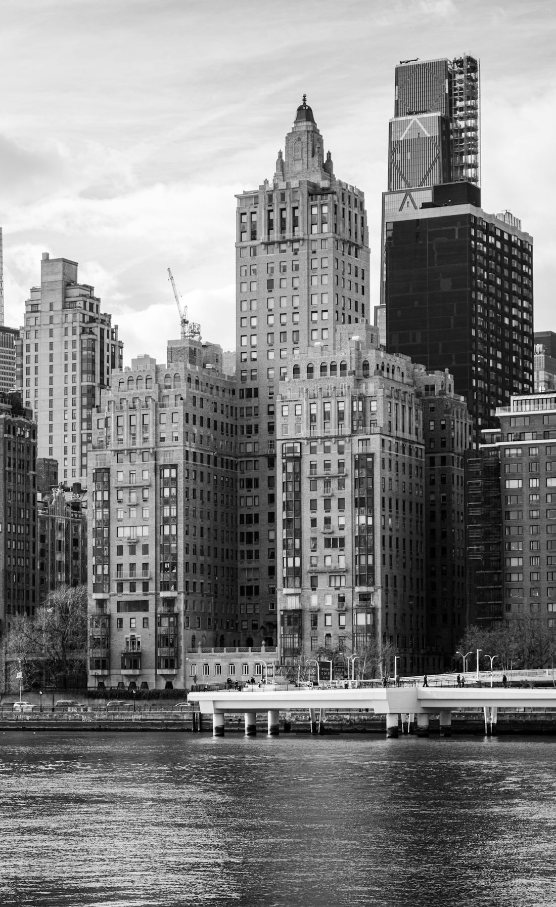 Buildings along a waterfront are seen in black and white.