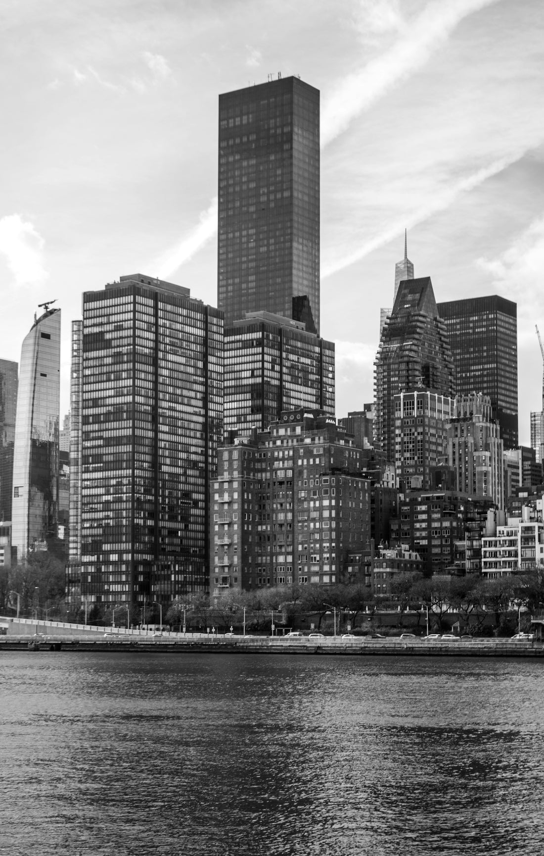 A city skyline is shown in black and white.