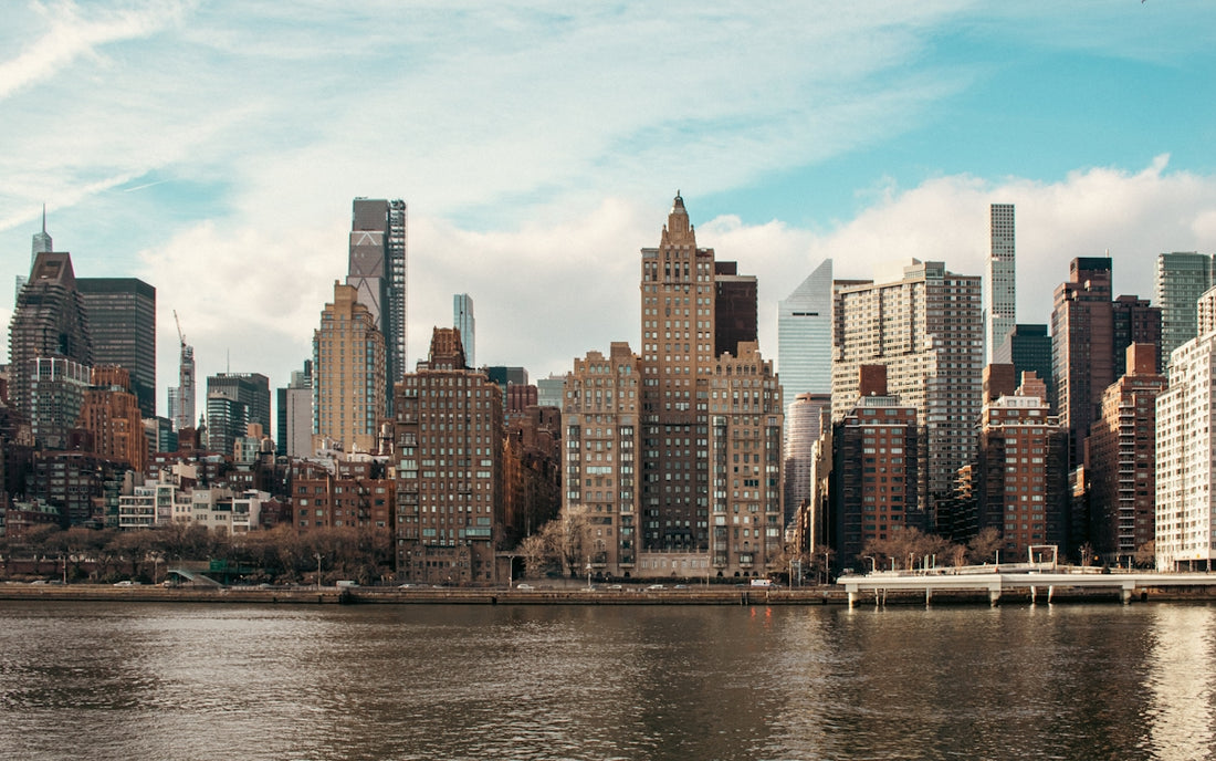 New york city skyline with a calm river.