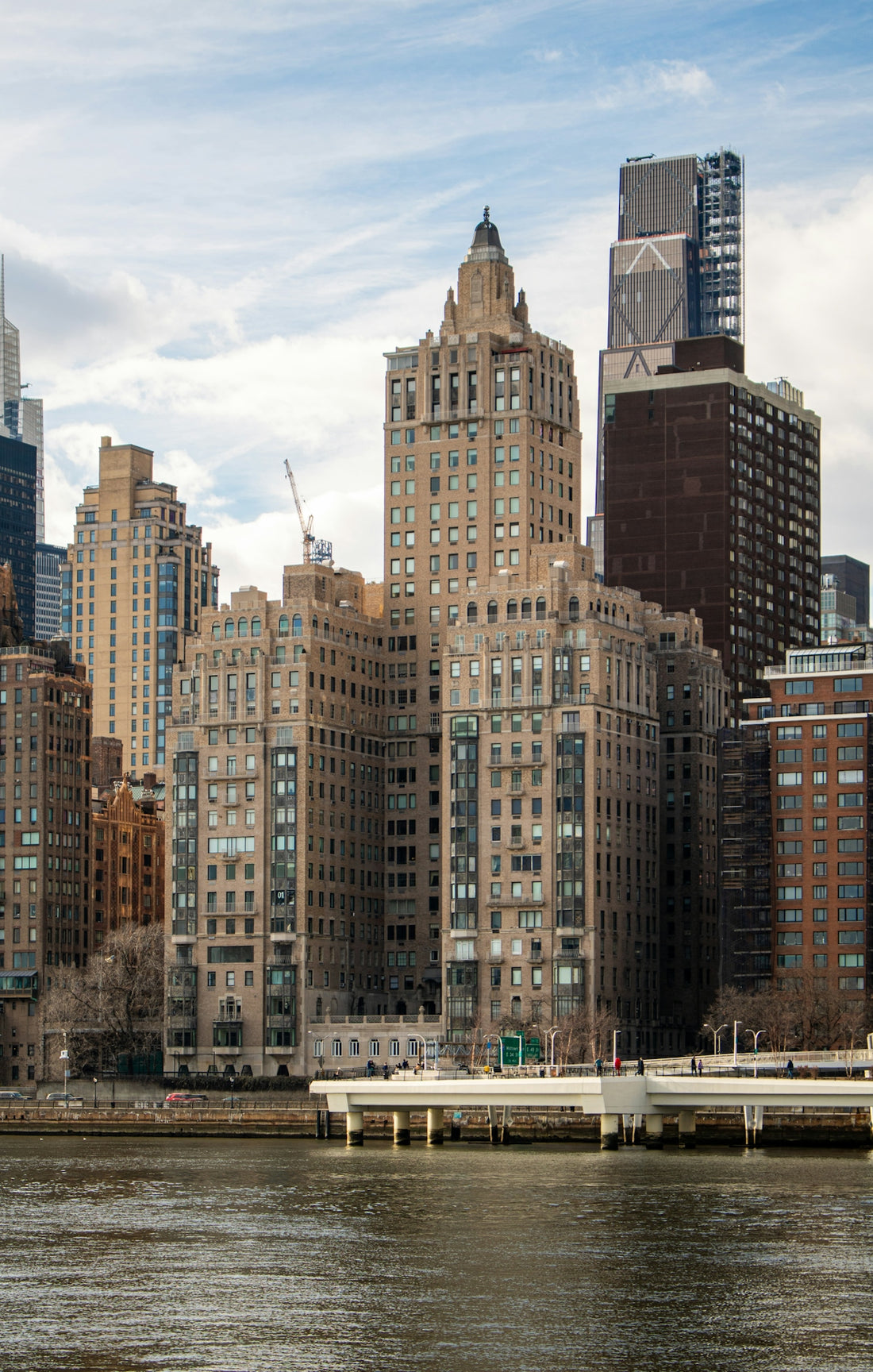 Skyscrapers line the river's edge on a cloudy day