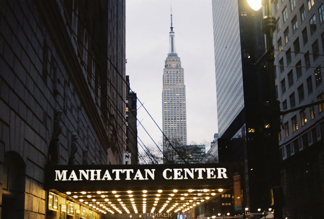 The empire state building is seen from manhattan center.