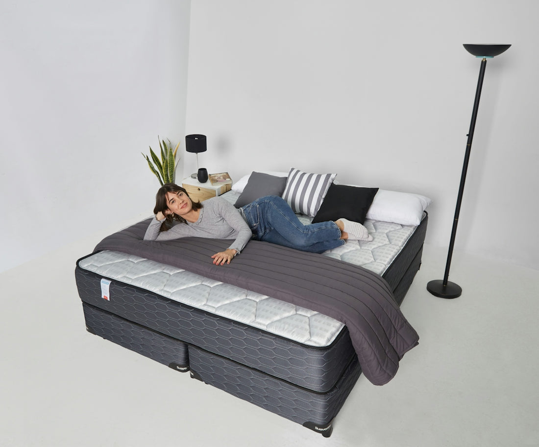 Woman relaxing on a large bed with pillows