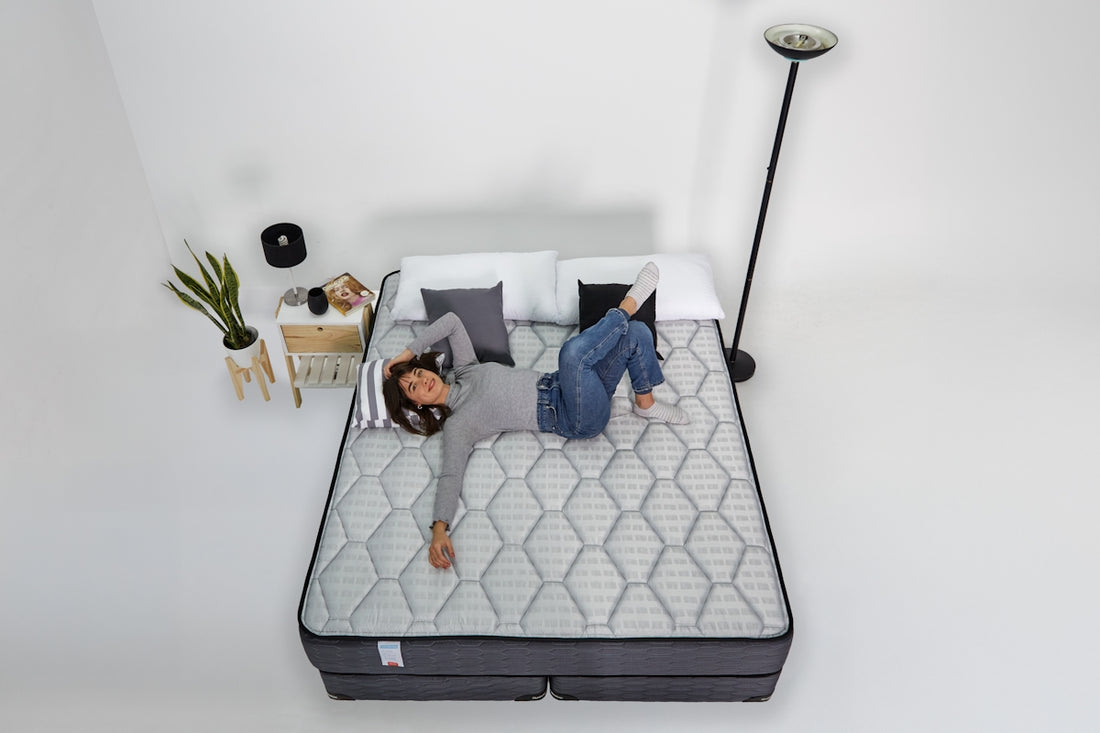 Woman relaxing on a mattress with headphones on.