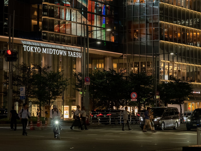 Tokyo midtown yaesu building at night with street traffic.