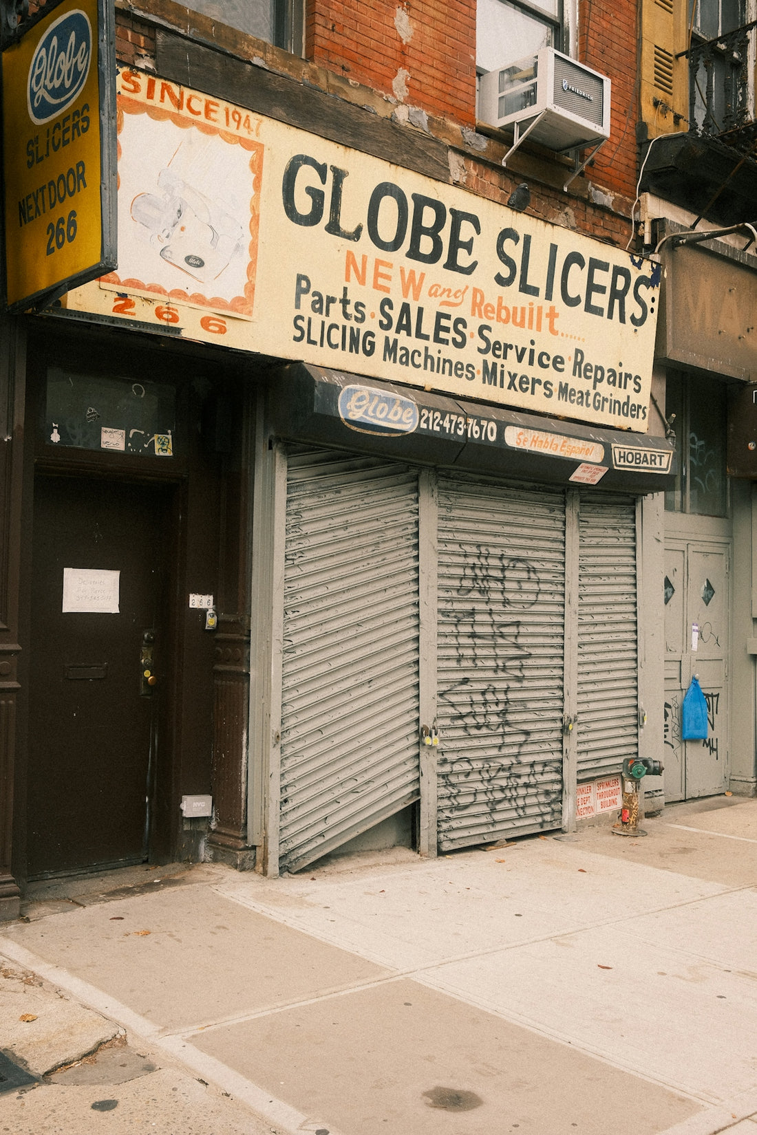 Globe slicers store with closed metal security gate.