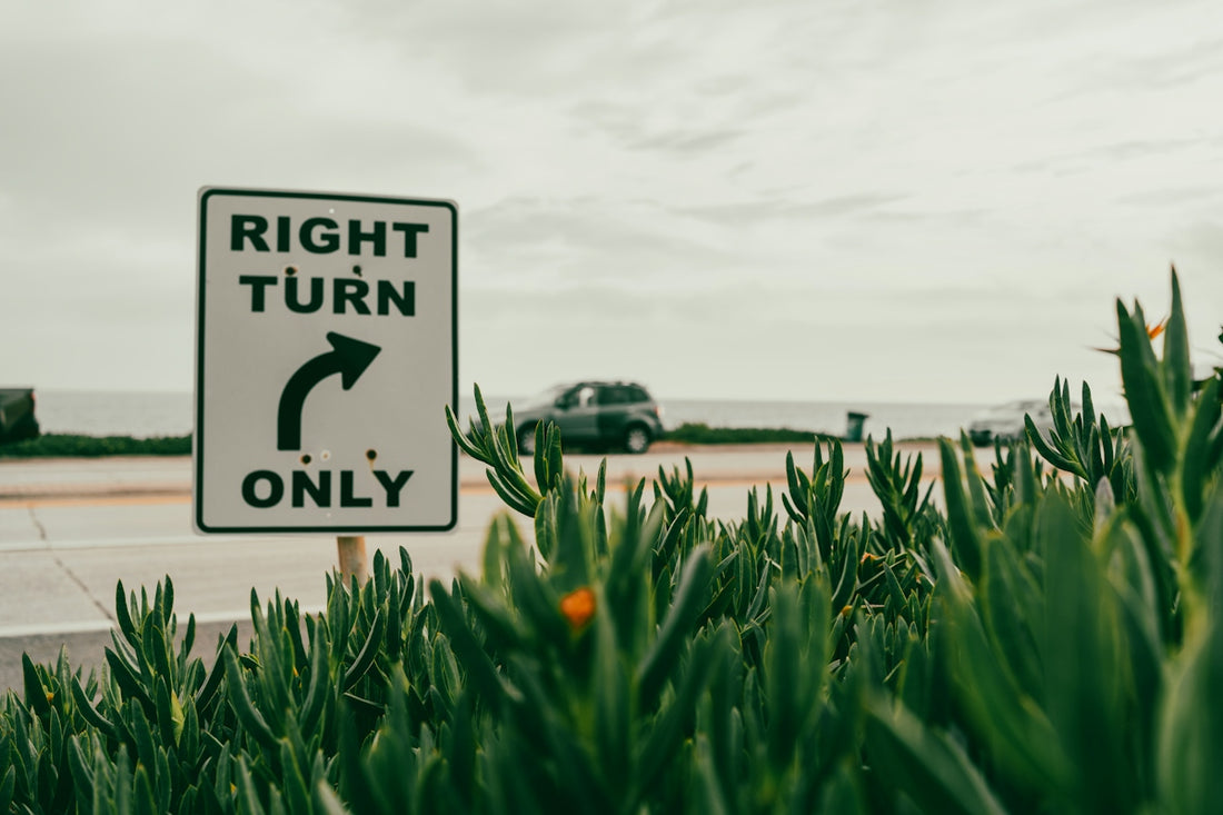 Right turn only sign with car in background