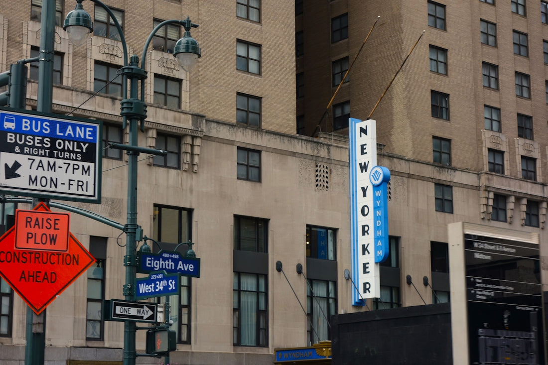 New yorker sign and street signs in a bustling city.